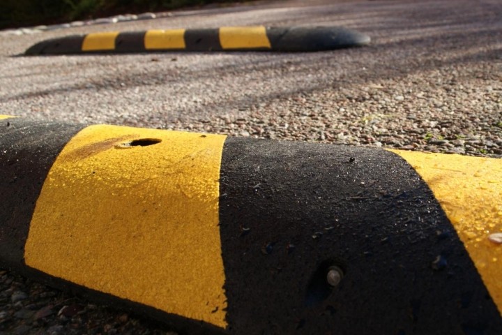 two black and yellow speedbumps in a road