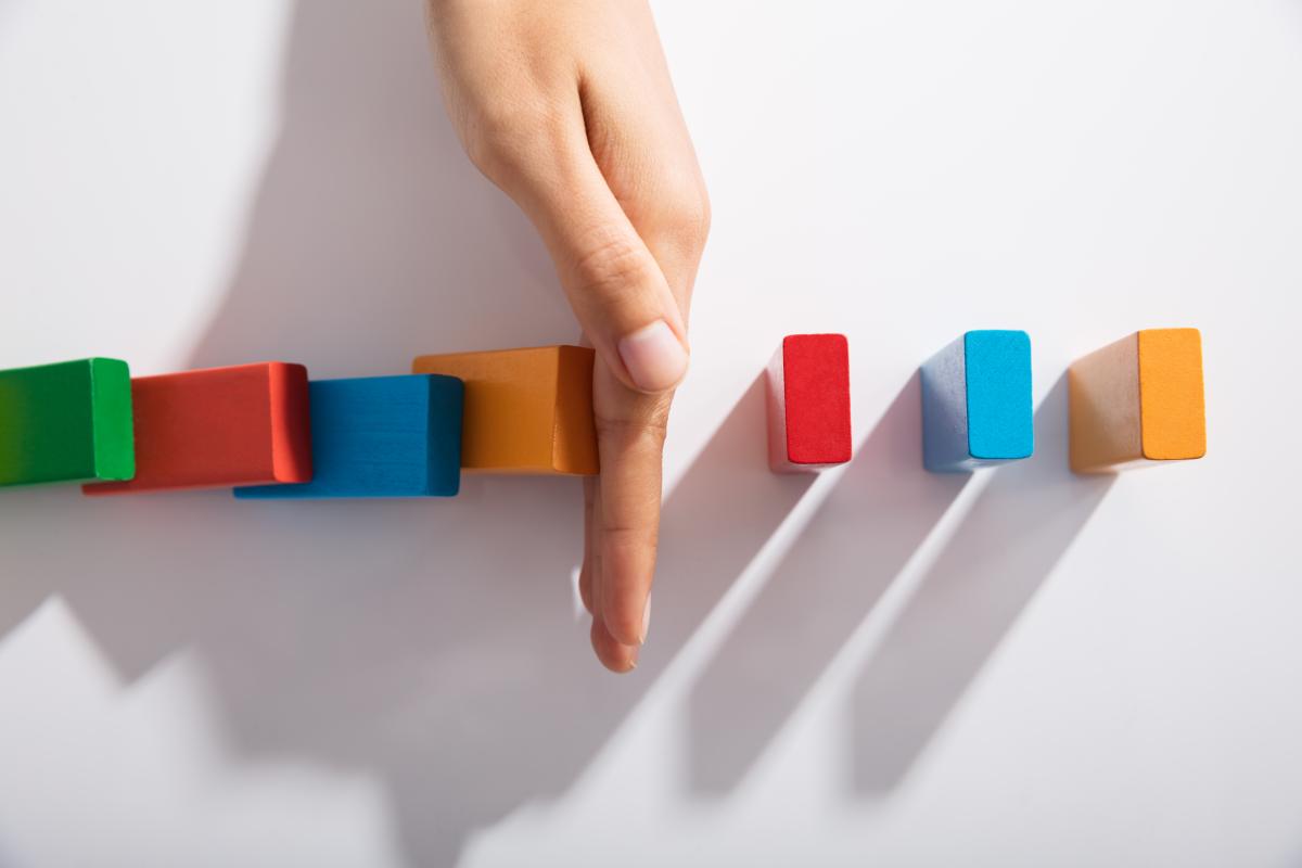 hand-keeping-colored-blocks-from-falling