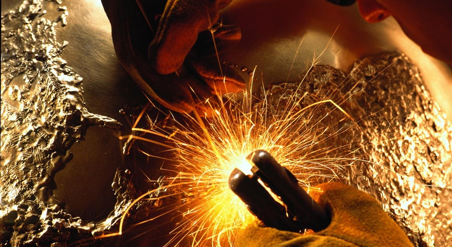 sculptor welding bronze globe