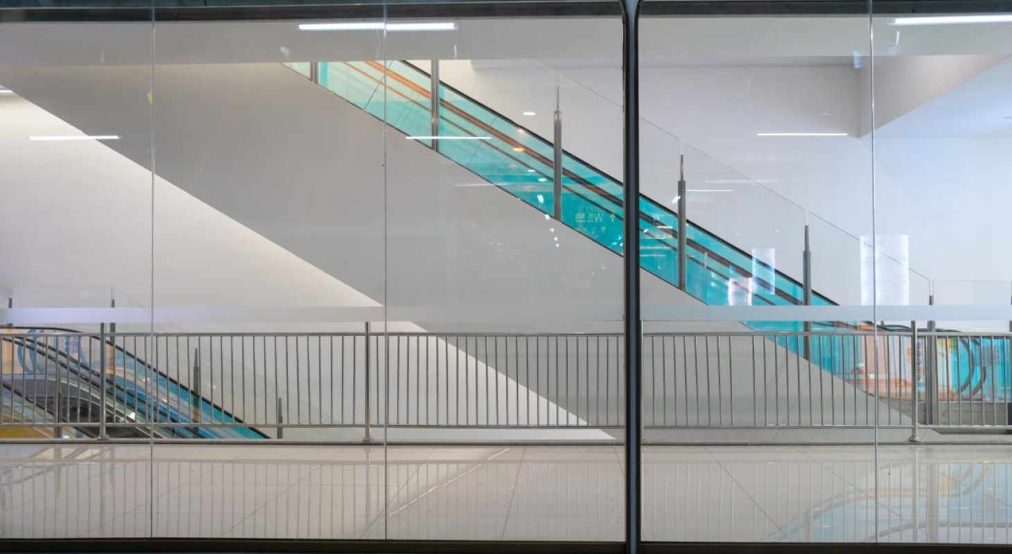 escalators framed with blue glass