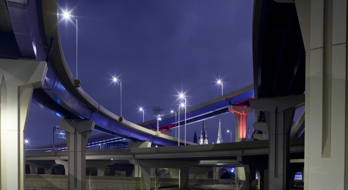 multiple highway off-ramps against dark blue sky