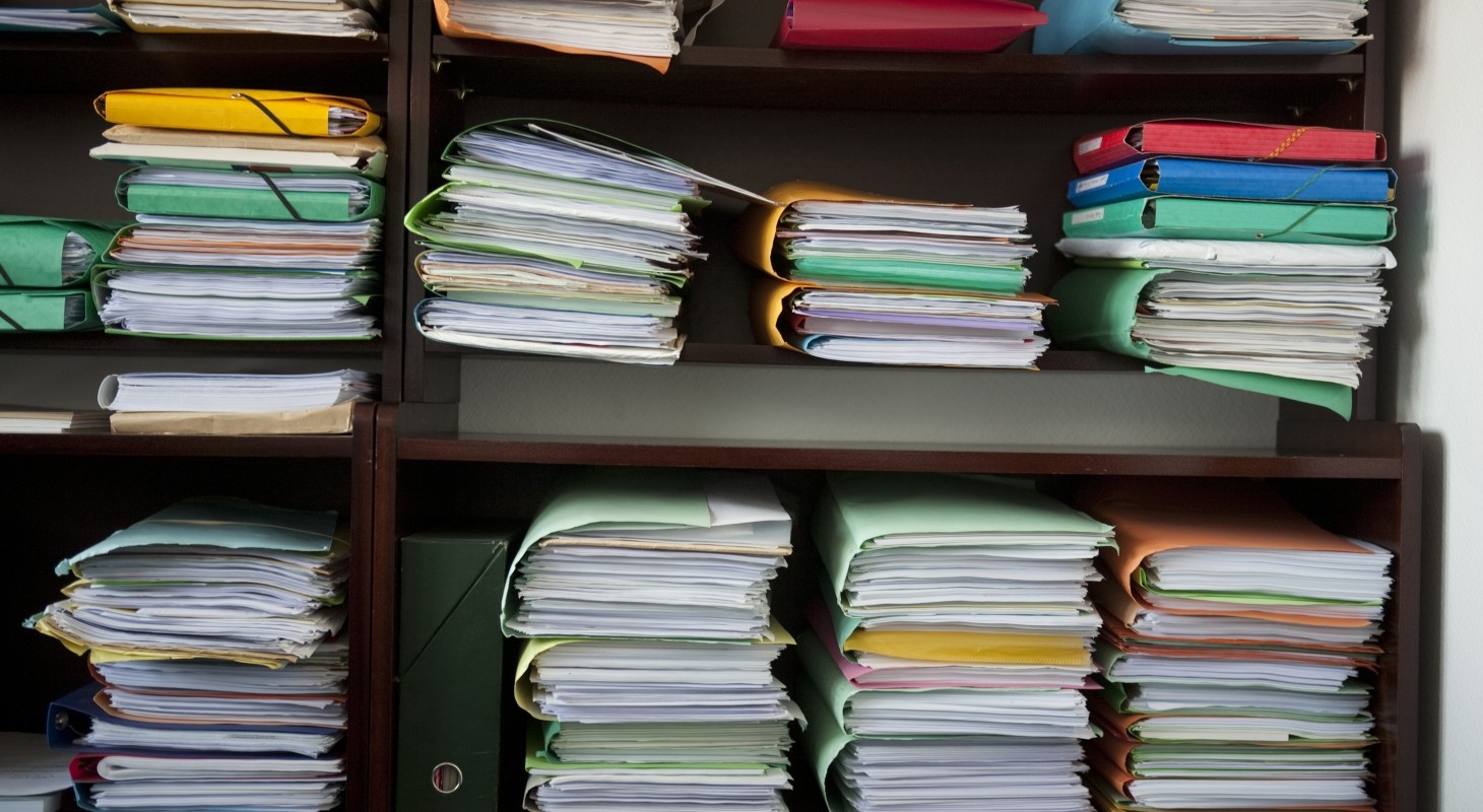 stacks of multicolored client files in lawyers office