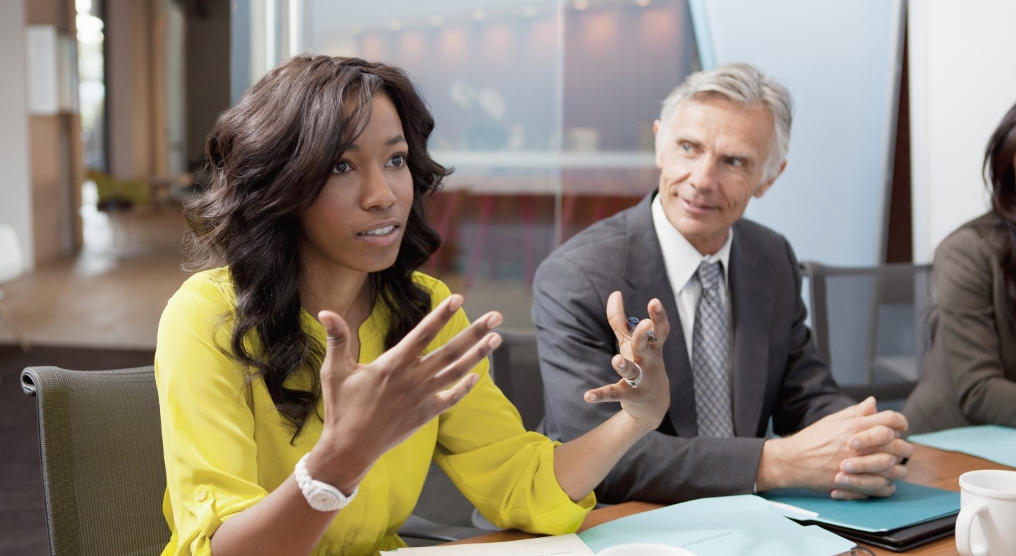 women with yellow shirt in business meeting
