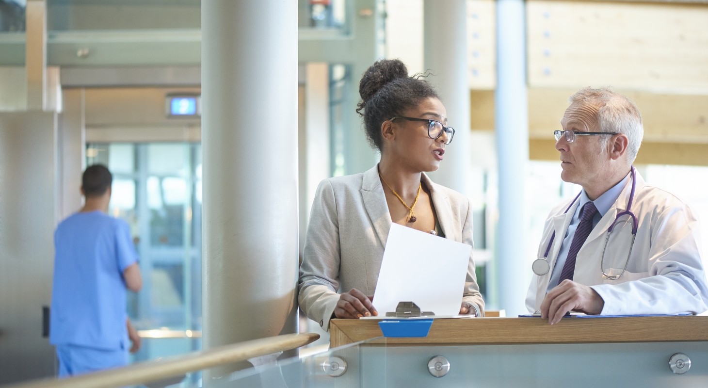 male and female hospital administrators discussing an issue