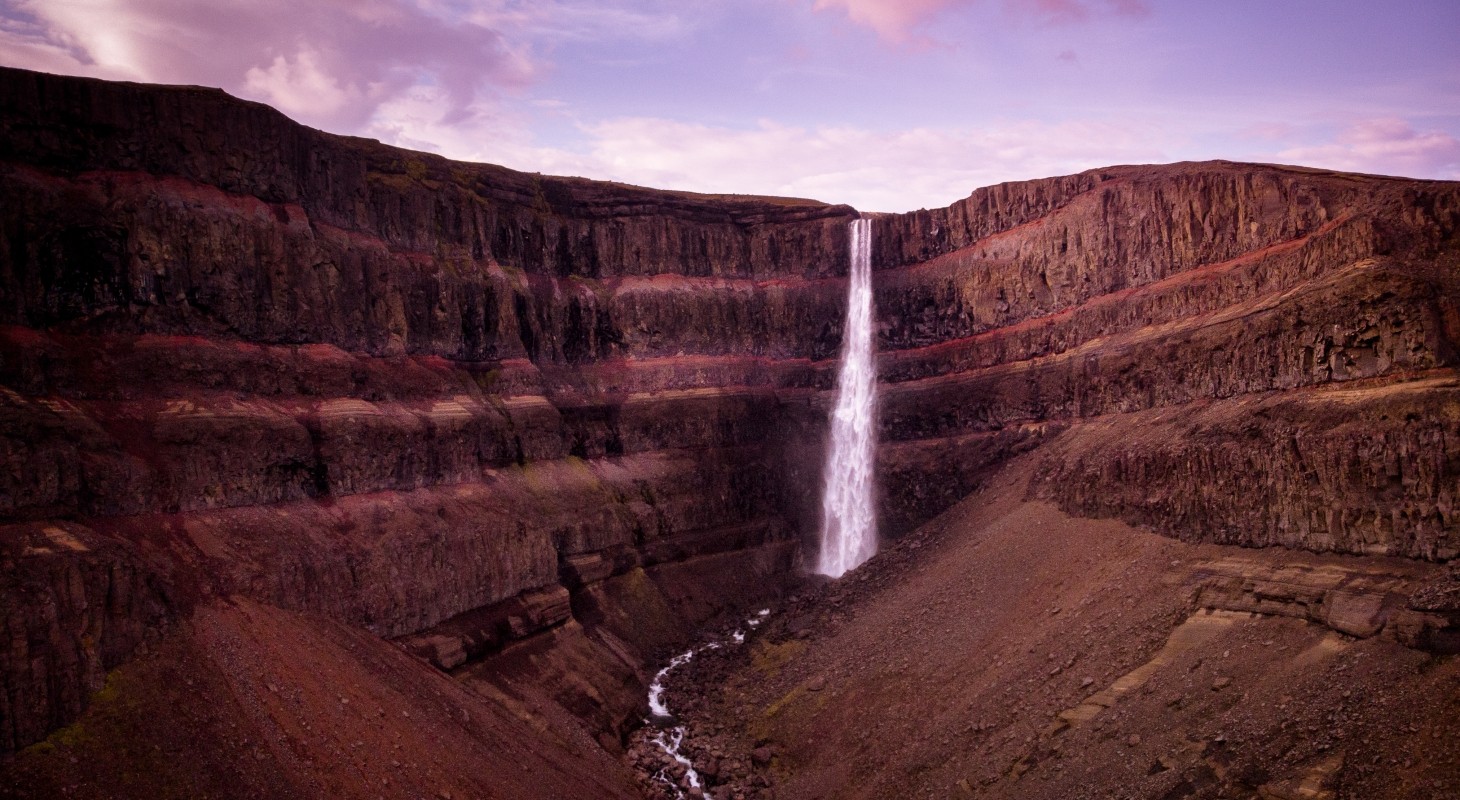 waterfall in iceland cascading into an almost dry riverbed