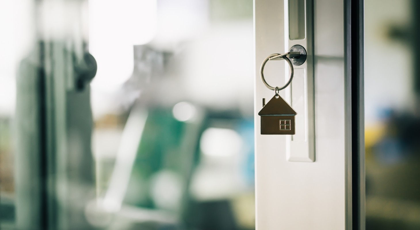 key ring with house charm in door lock