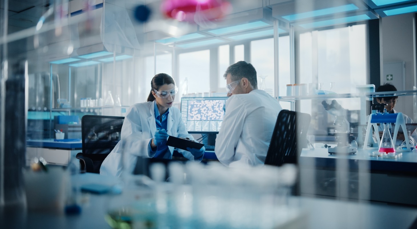 two scientists in lab discussing results