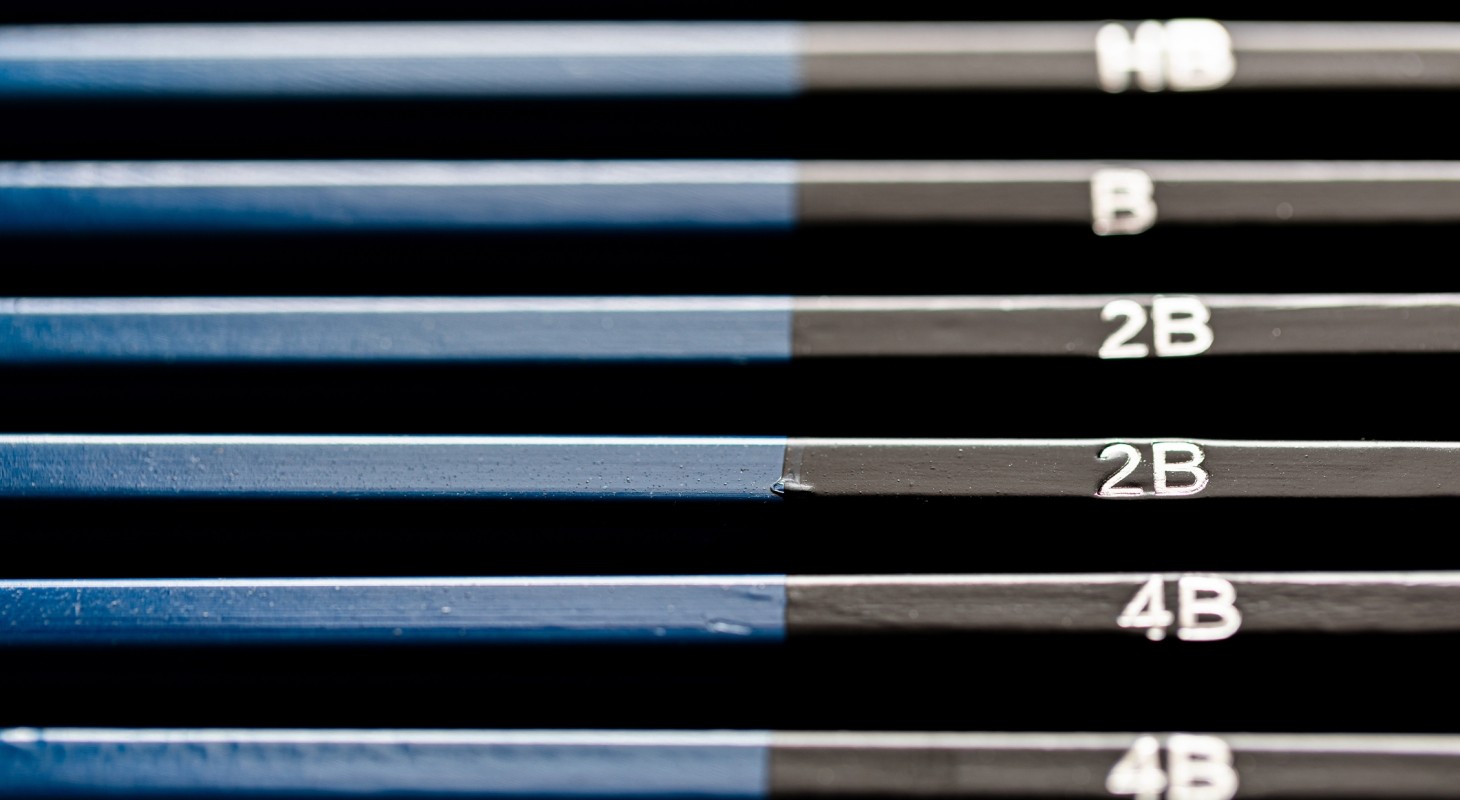 stacked set of blue and black pencils