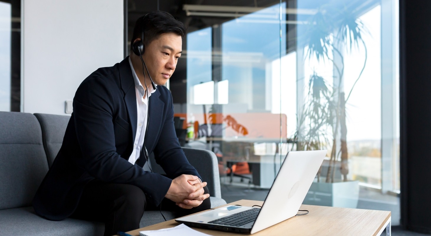 asian male executive in office on video conference