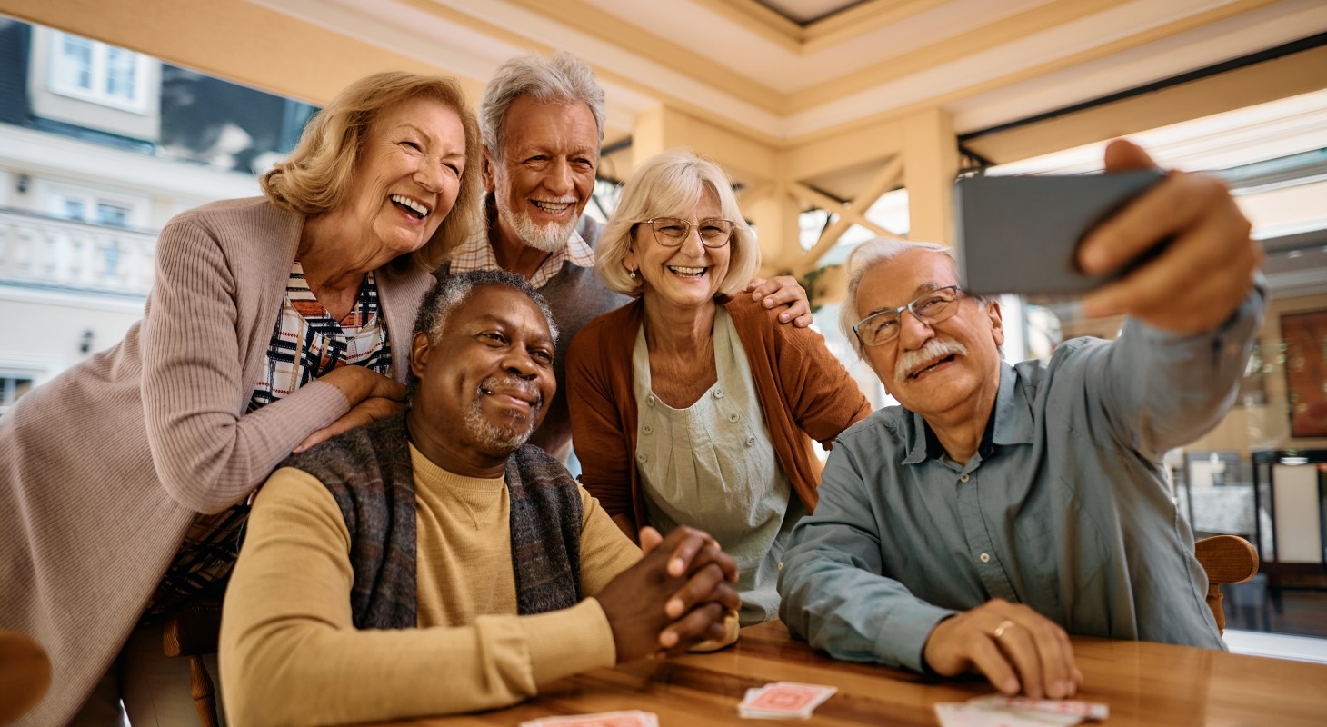 multi racial group of seniors taking selfie