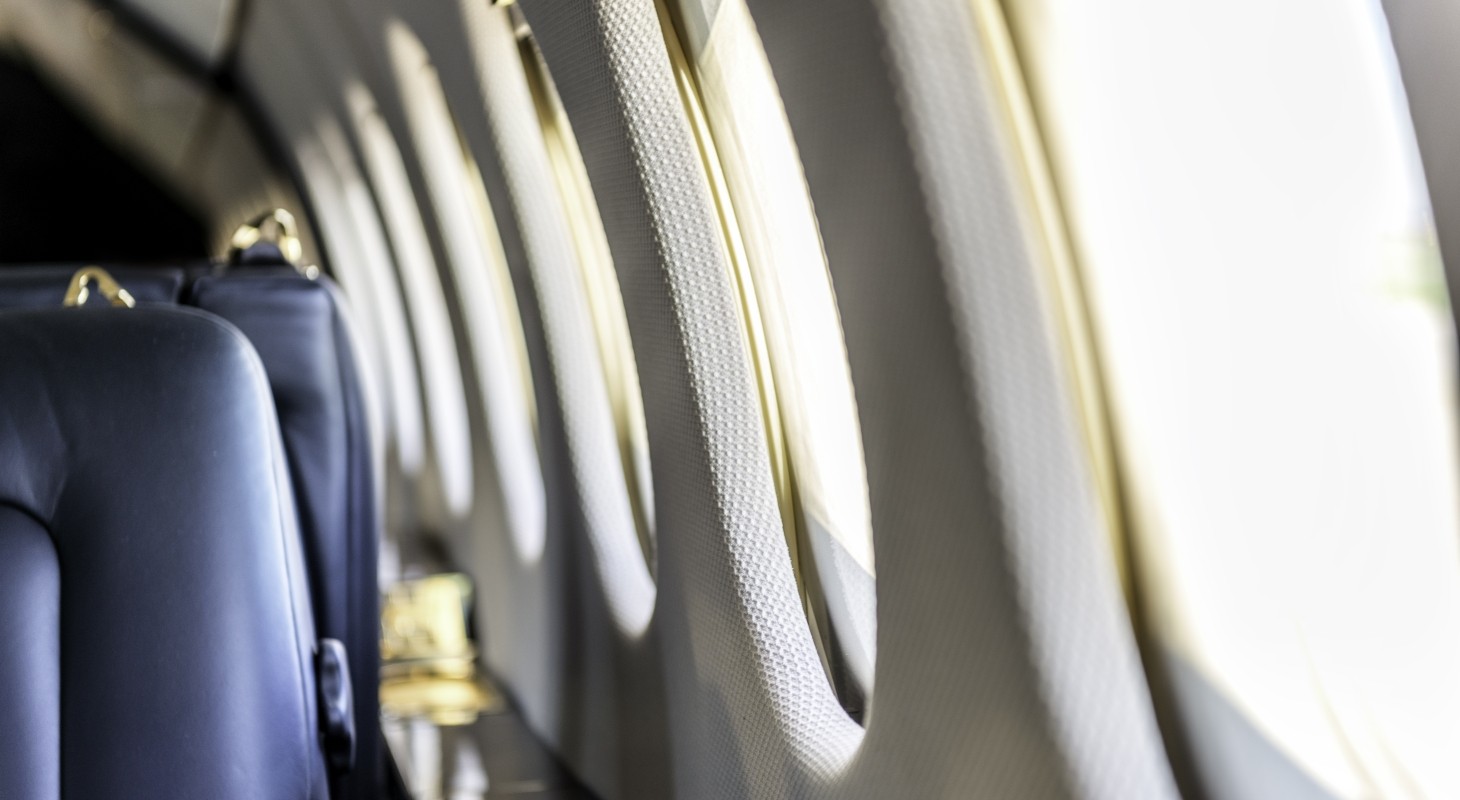 interior of private jet with blue seats