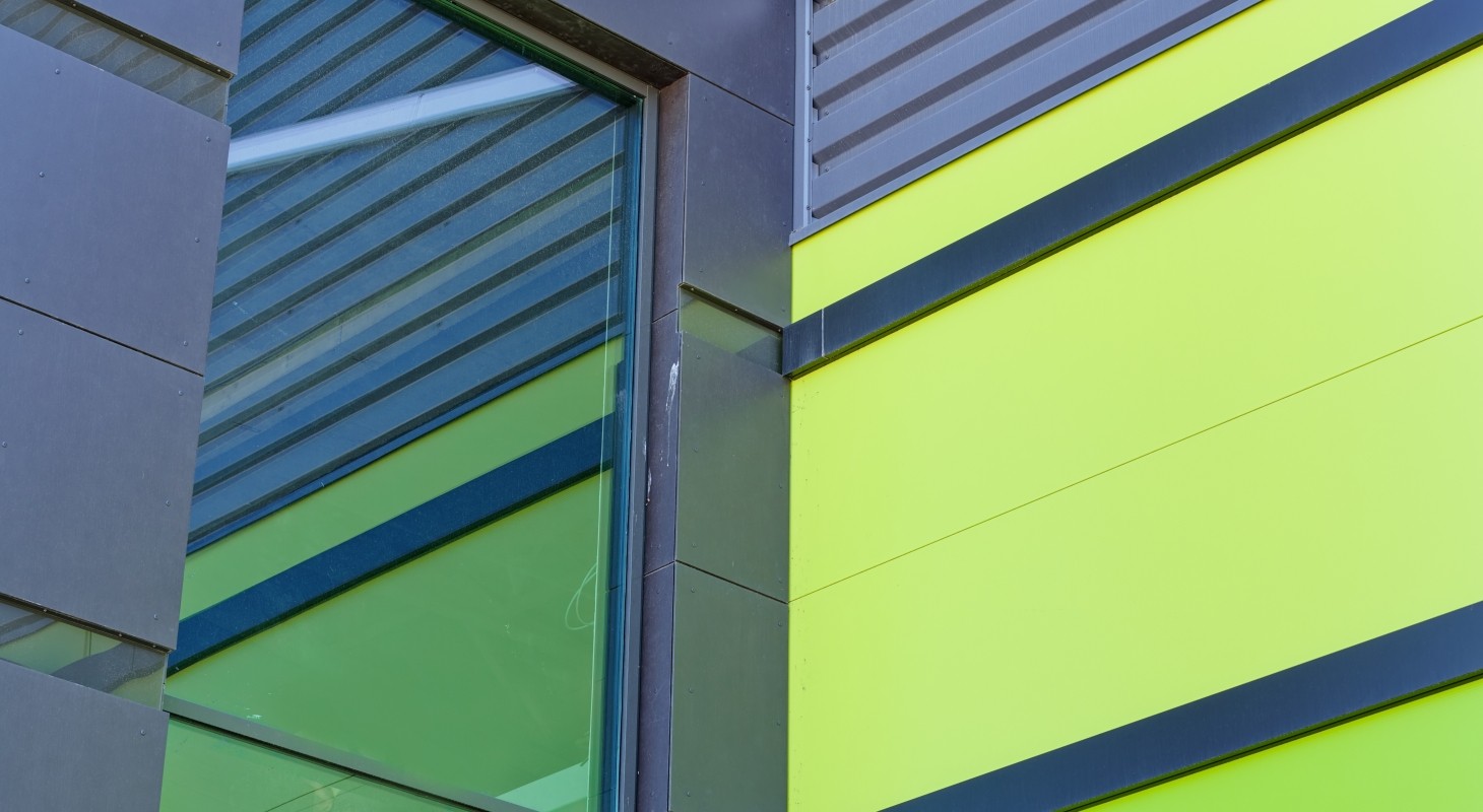 close up of bright blue and lime aluminum facade on industrial building