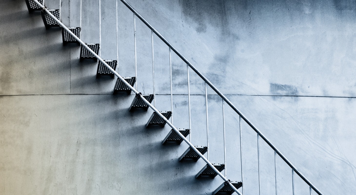 simple metal stairs against concrete wall