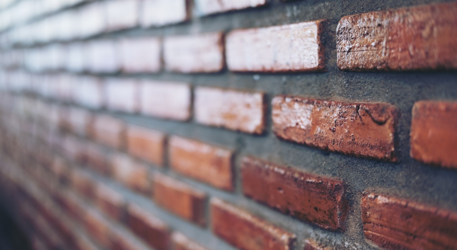 angled closeup view of red brick wall