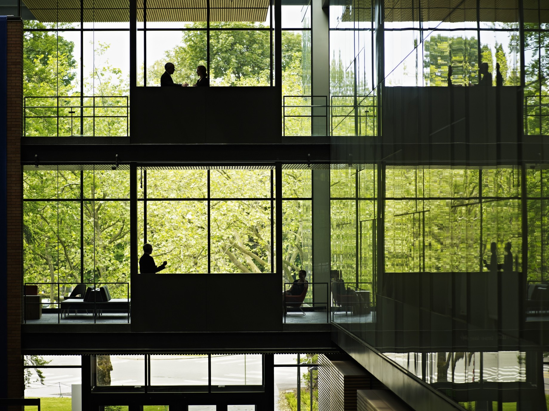 multiple levels in a glass building with executives on various floors