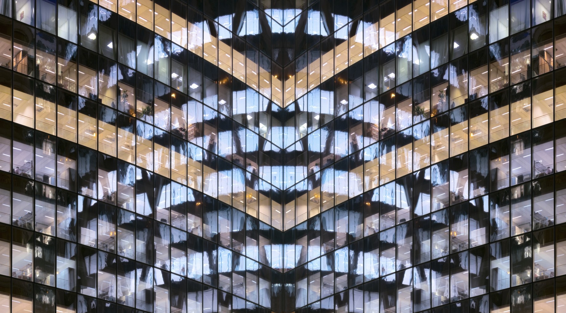 glass office building with facade reflected