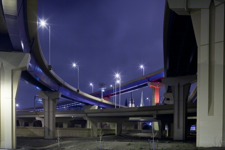 multiple highway off-ramps against dark blue sky