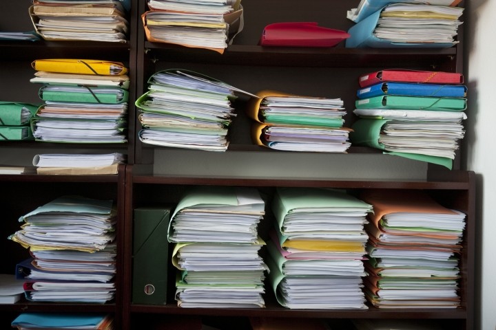 stacks of multicolored client files in lawyers office