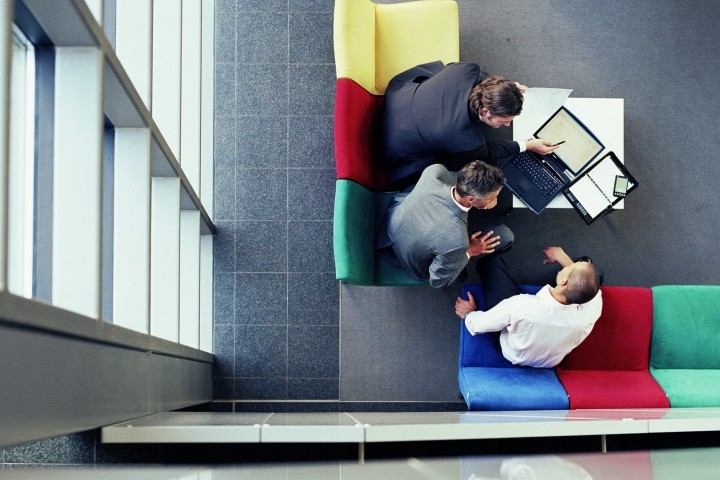 three businessmen in meeting, overhead view