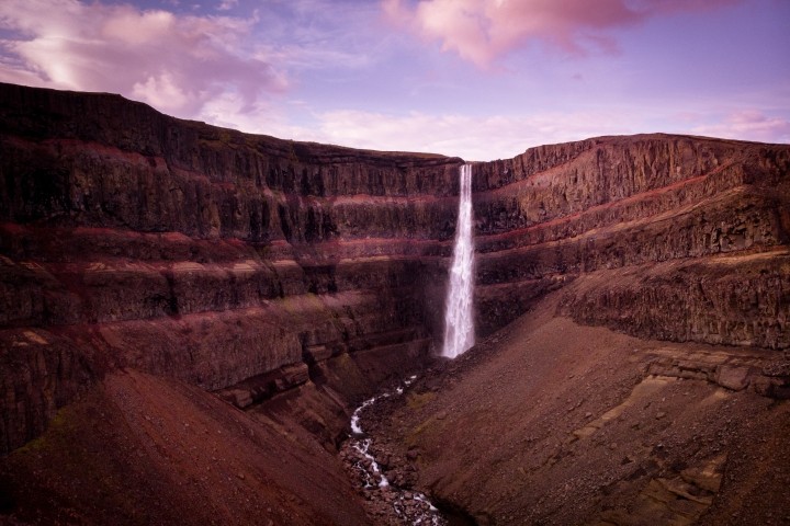 waterfall in iceland cascading into an almost dry riverbed