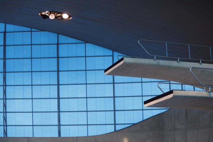 two indoor high diving platforms over empty pool