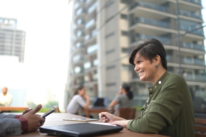 male and female colleagues having work meeting in outdoors setting