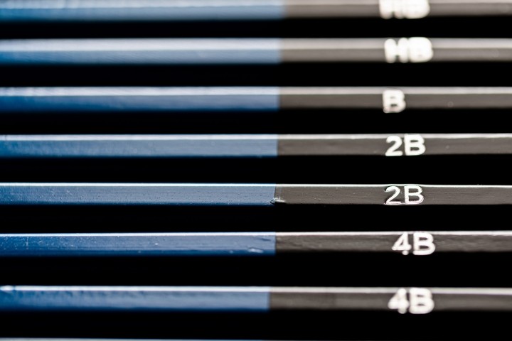 stacked set of blue and black pencils