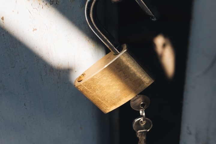 medal padlock with two keys on old garage door