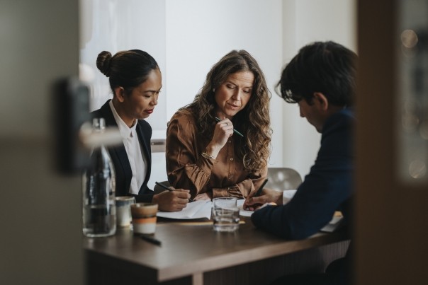 young businessman writing in a meeting