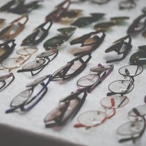 selection of eyeglasses frames on gray table