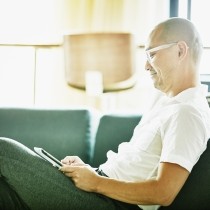 casually dressed director reading email on phone