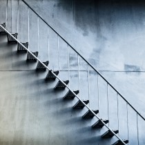 simple metal stairs against concrete wall